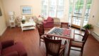OVGH Sitting Area 3 Checkers Table, Couch, Large Windows