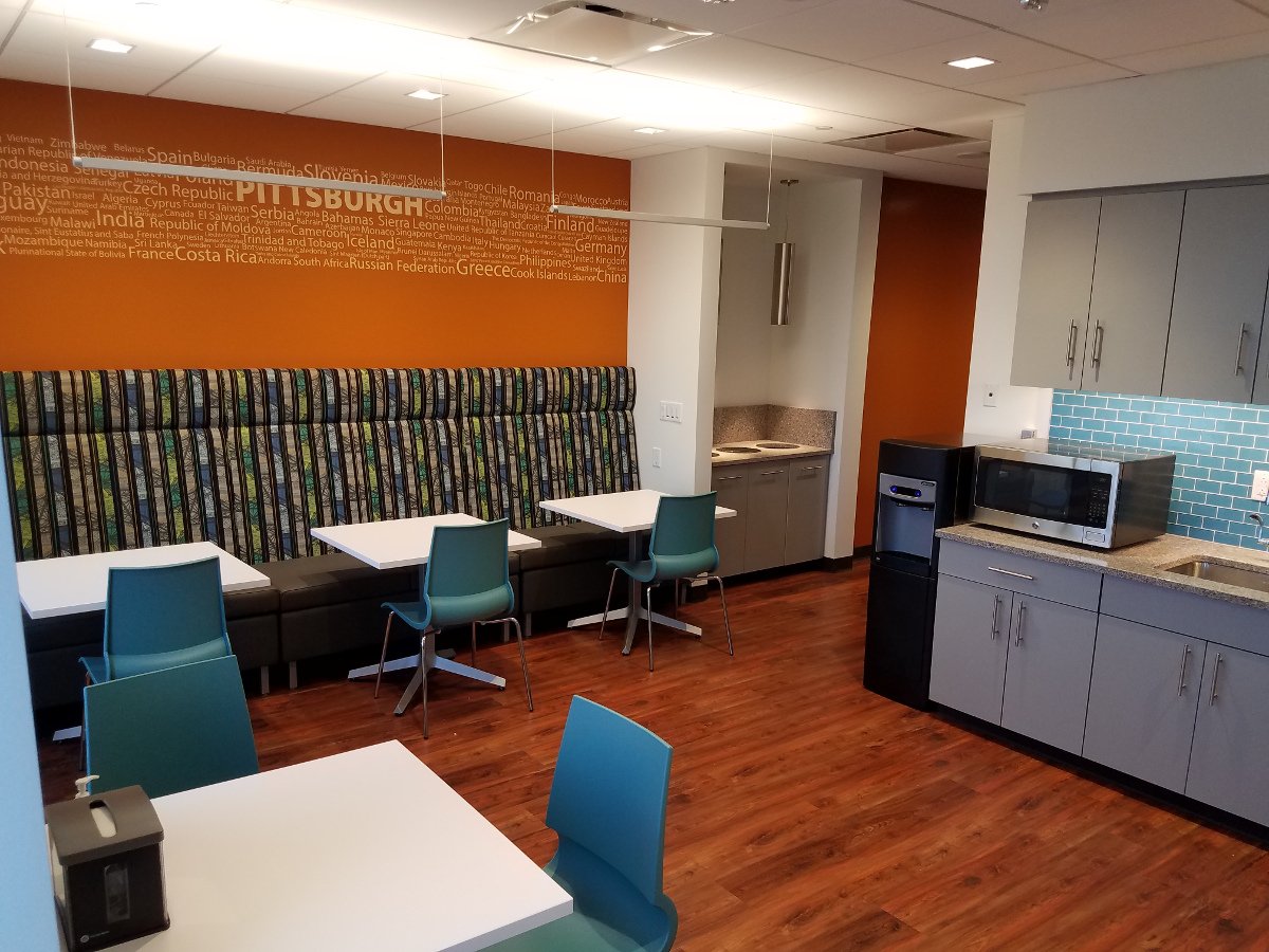 Dining Area Seating, wood floor, blue chairs, orange wall
