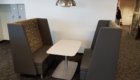 Booth style seating, table, whiteboard wall