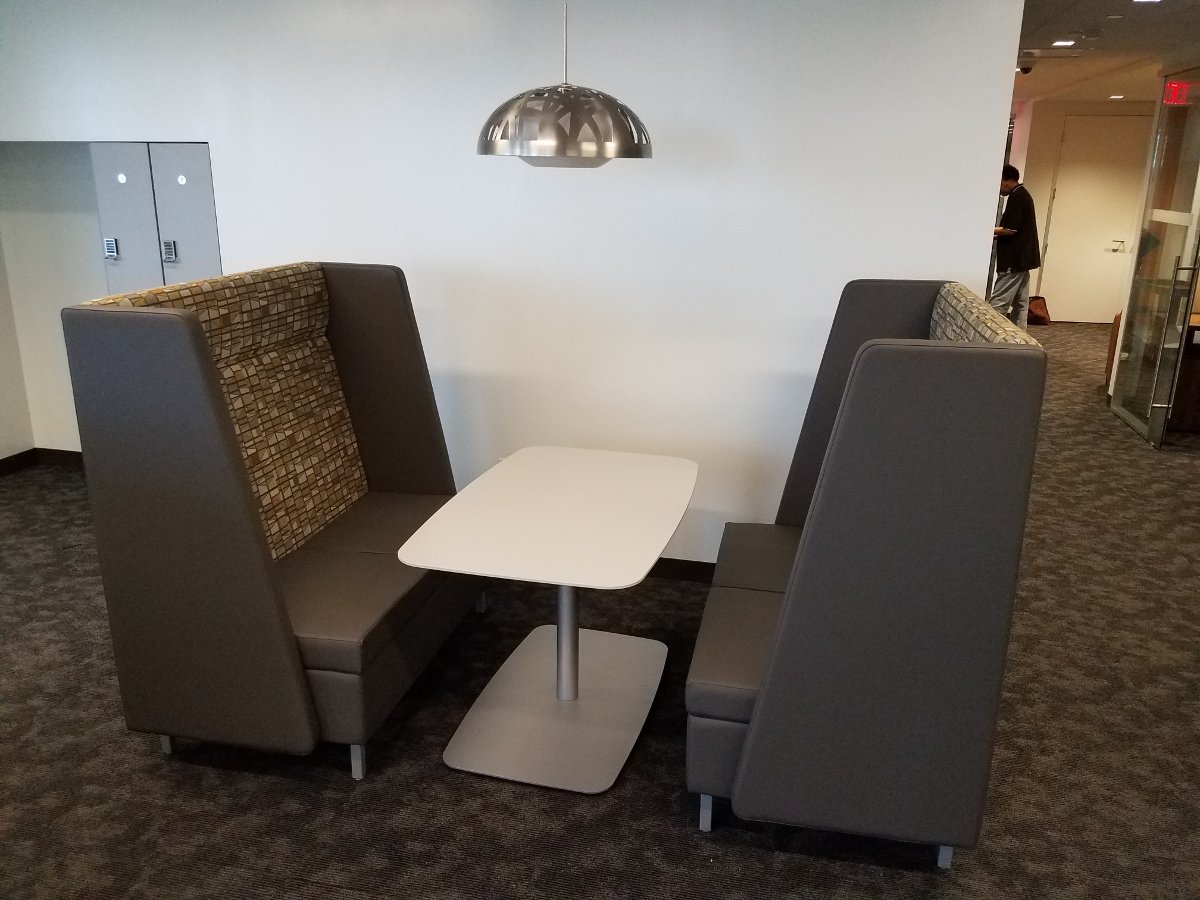 Booth style seating, table, whiteboard wall